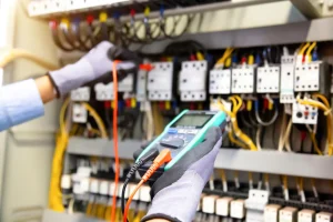 electrical-engineer-using-digital-multi-meter-measuring-equipment-checking-electric-current-voltage-circuit-breaker-cable-wiring-system-main-power-distribution-board_545582-823